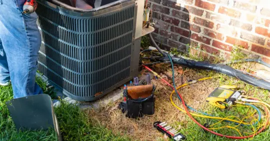 AC technician working on unit