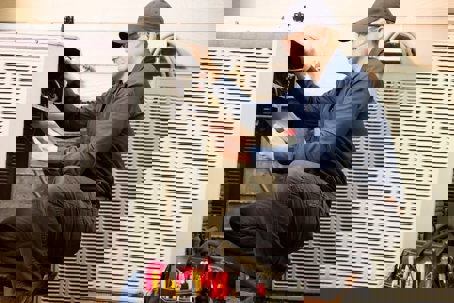 AC technician checking the units