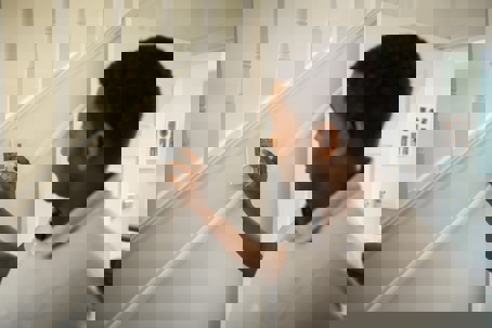 Man turning on the Thermostat