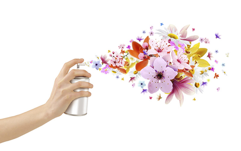 a hand spraying an aerosol can, releasing a burst of colorful flowers,