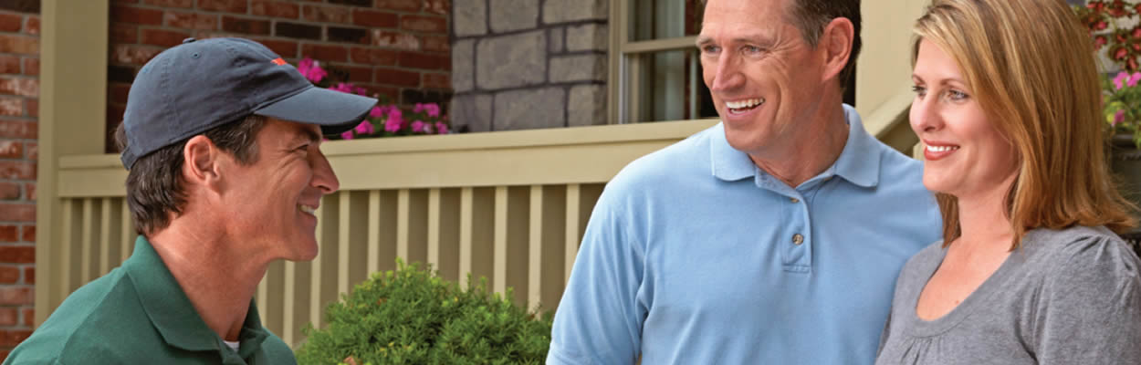 Couple Talking To Trane Dealer Outside House Couple Talking To Trane Dealer Outside House
