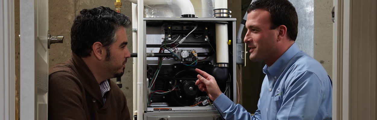 Trane Tech Talking To Customer Next To Furnace Trane Tech Talking To Customer Next To Furnace